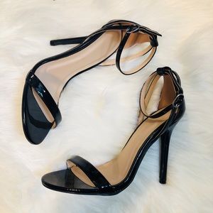 Black strappy patent leather heels.